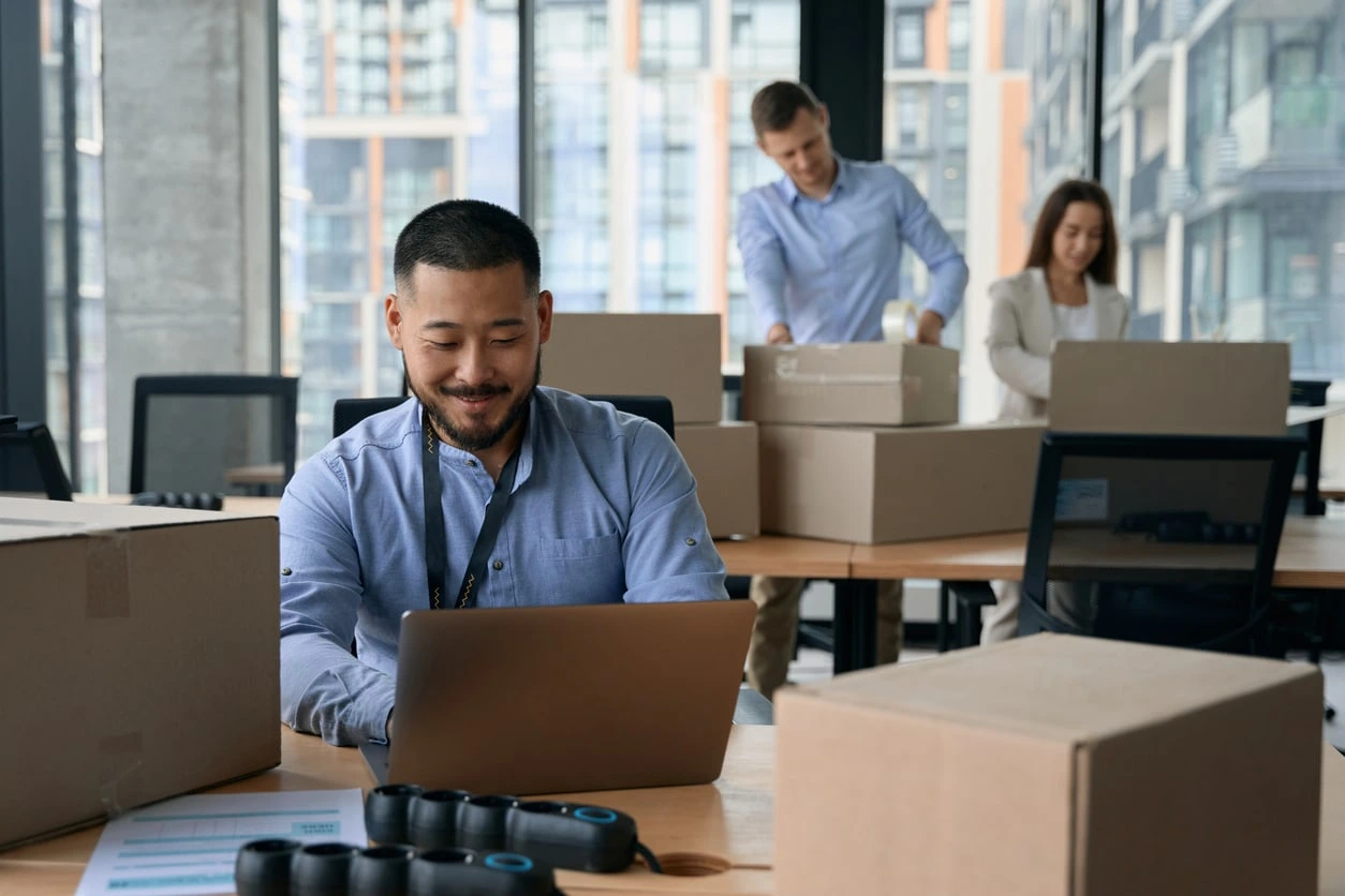 People in an office packing boxes